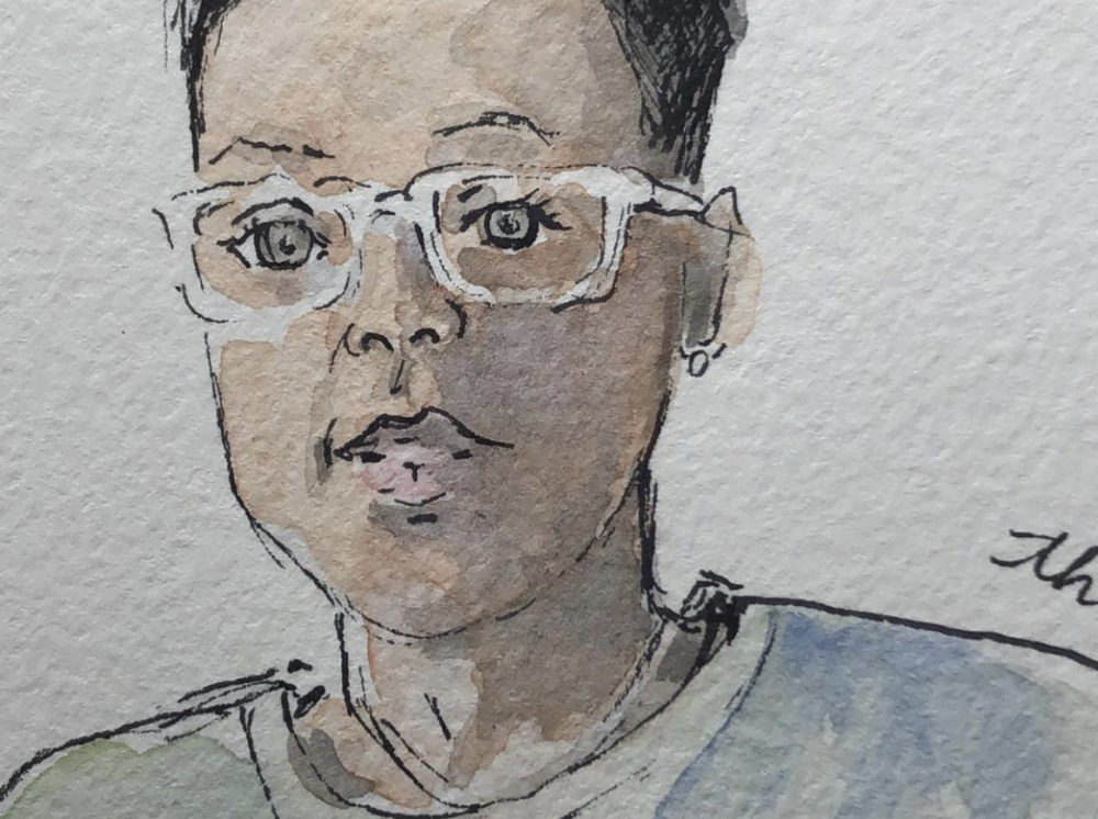 A close-up  of an ink and watercolor drawing of a woman with short hair, a blue shirt, and white glasses.